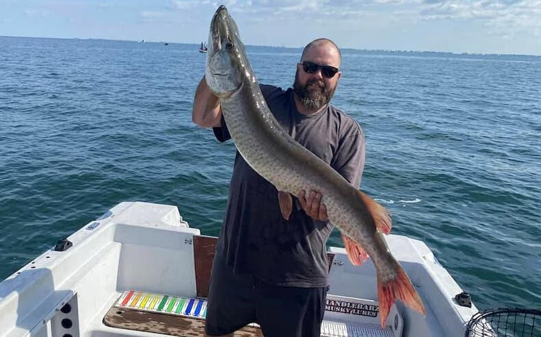 Reaper Musky Charters Reaper Musky Charters guide holding a massive musky catch