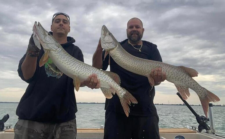 Guides with 2 Muskies Two giant muskies caught on Lake St. Clair with Reaper Musky Charters